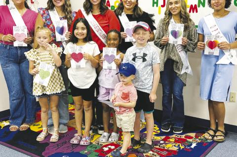 A group photo with Harvest Festival Queen, candidates